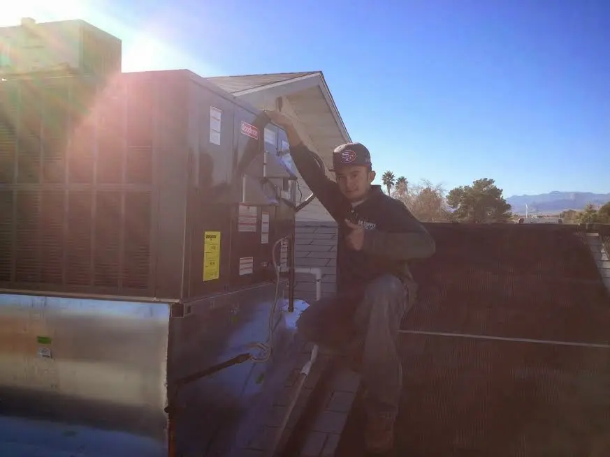 HVAC technician performing Heat Pump Repair on a rooftop unit in Socastee
